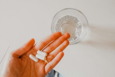 person holding white medication pill
