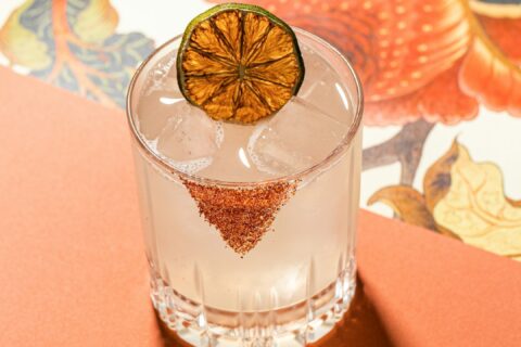 a glass with a orange slice on top of it