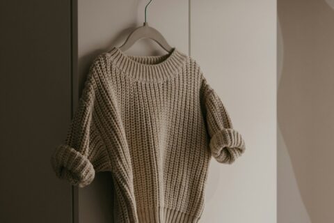 a sweater hanging on a hook in a room