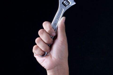 person holding gray and black metal tool