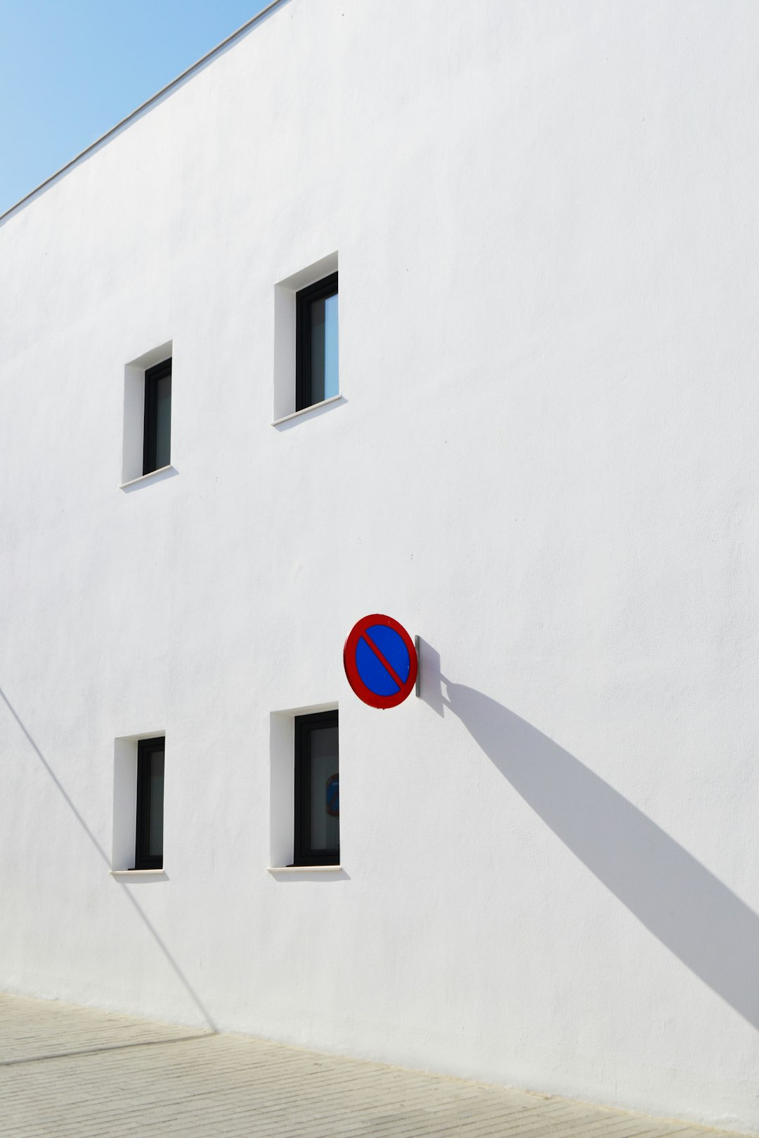 A white building with no parking sign.