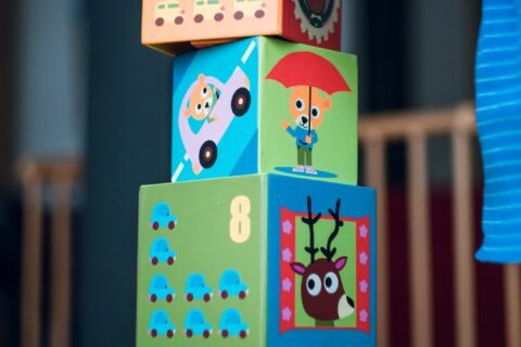 child building an four boxes