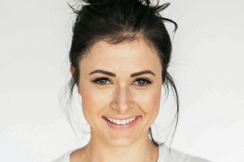 woman in white crew neck shirt smiling