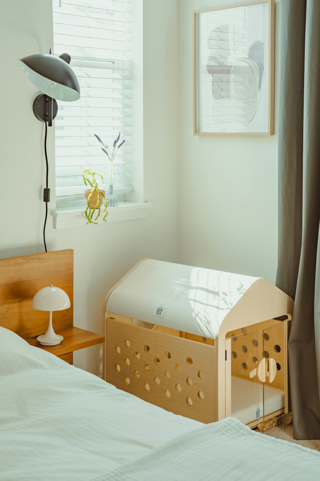 Wooden baby crib next to a bed in a room