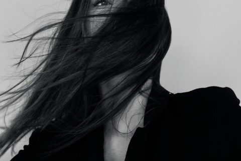 grayscale photography of woman wearing long-sleeved shirt